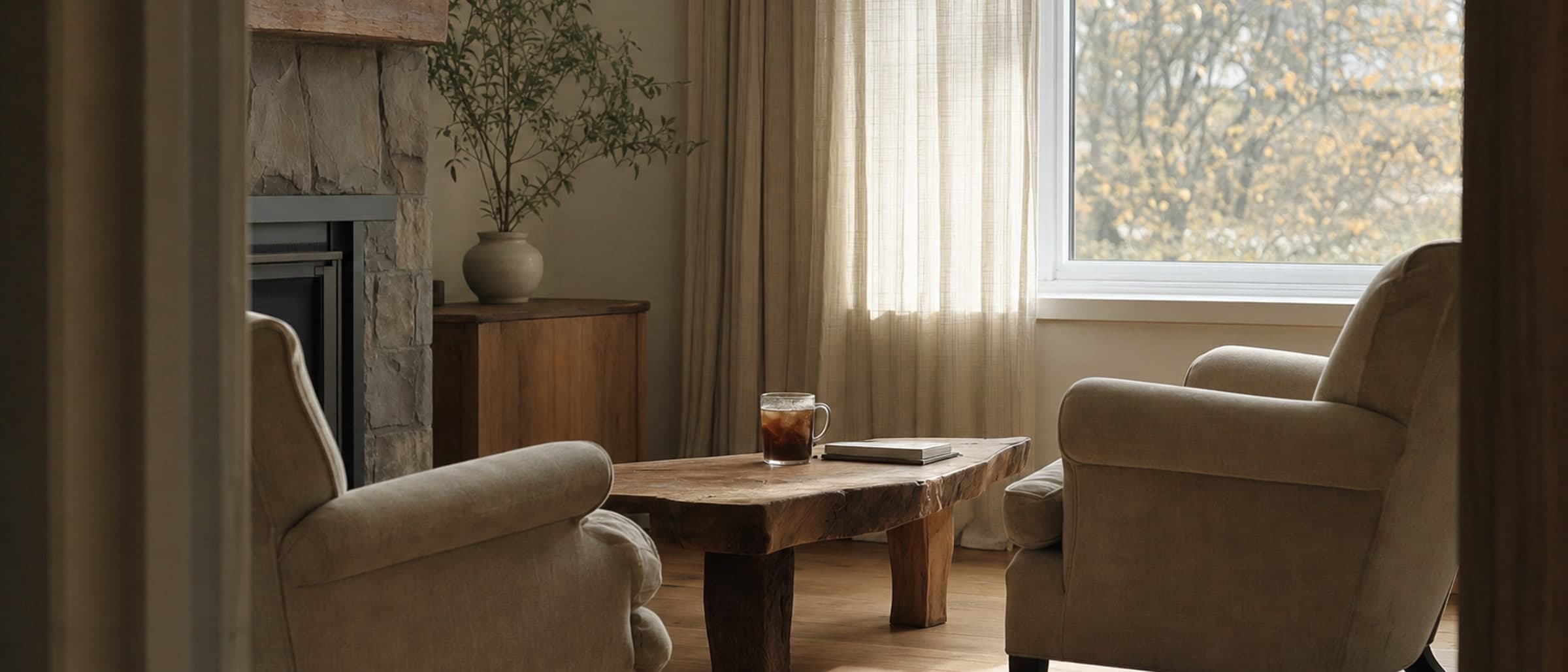 Two empty armchairs facing each other across a low table in a quiet room
